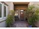 Charming entrance with lush greenery, bench seating and a secure front door at 240 Jumping Springs Pl, Henderson, NV 89012