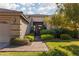 Lovely home with a well-kept lawn, mature trees, and a welcoming brick pathway at 240 Jumping Springs Pl, Henderson, NV 89012