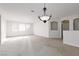 Spacious, light-filled living room with plantation shutters and neutral carpet at 240 Jumping Springs Pl, Henderson, NV 89012