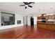 Hardwood floors and open floor plan flow between the living room, kitchen and fireplace at 240 Jumping Springs Pl, Henderson, NV 89012