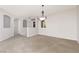 Expansive living room showcasing arched doorways, neutral tones, and plantation shutters at 240 Jumping Springs Pl, Henderson, NV 89012