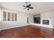 Bright living room featuring hardwood floors, fireplace, and plantation shutters at 240 Jumping Springs Pl, Henderson, NV 89012