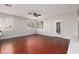 Inviting living room showcasing hardwood floors, plantation shutters, and access to outdoor space at 240 Jumping Springs Pl, Henderson, NV 89012