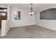 Inviting living room boasts carpet, window shutters, and a stylish chandelier at 240 Jumping Springs Pl, Henderson, NV 89012