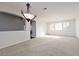 Bright, open living room with neutral carpet and plantation shutters at 240 Jumping Springs Pl, Henderson, NV 89012