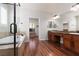 Well-lit Primary bathroom with double vanities, a luxurious soaking tub and separate walk-in shower at 240 Jumping Springs Pl, Henderson, NV 89012
