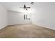 Large primary bedroom with neutral carpet, ceiling fan and bright window with plantation shutters at 240 Jumping Springs Pl, Henderson, NV 89012