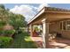 Relaxing covered patio area featuring brick flooring, lush landscaping and ceiling fans at 240 Jumping Springs Pl, Henderson, NV 89012