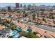 Neighborhood aerial view featuring backyard pools, mature landscaping, and Las Vegas cityscape at 2712 Sidonia Ave, Las Vegas, NV 89102