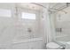 Elegant bathroom featuring marble tile, glass shower doors and soaking tub at 2712 Sidonia Ave, Las Vegas, NV 89102