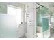 A luxurious shower with a glass enclosure features marble walls, a rainfall shower head and sleek, modern fixtures at 2712 Sidonia Ave, Las Vegas, NV 89102