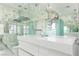 This bathroom features a modern vanity, toilet, vessel sink and expansive mirrors that bounce the natural light around at 2712 Sidonia Ave, Las Vegas, NV 89102