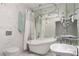 A traditional clawfoot tub is the focal point of this vintage-inspired bathroom with marble tiles and unique fixtures at 2712 Sidonia Ave, Las Vegas, NV 89102