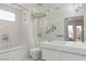 Luxurious bathroom featuring marble tile, glass shower doors, and modern vanity at 2712 Sidonia Ave, Las Vegas, NV 89102