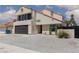 Charming two-story home featuring a balcony, desert landscaping, and a two-car garage at 2712 Sidonia Ave, Las Vegas, NV 89102
