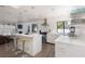Modern kitchen featuring sleek white cabinetry, stainless steel appliances, and a central island with bar stools at 2712 Sidonia Ave, Las Vegas, NV 89102