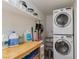Functional laundry room features stacked washer and dryer and ample shelving and wood countertop at 2712 Sidonia Ave, Las Vegas, NV 89102