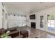 Bright living room featuring white walls, modern fireplace, hardwood floors, and dining area at 2712 Sidonia Ave, Las Vegas, NV 89102