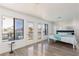 Bright main bedroom with walkout balcony access, stylish wall paper and hardwood floors at 2712 Sidonia Ave, Las Vegas, NV 89102