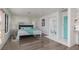 Serene bedroom with hardwood floors, patterned wallpaper, and an ensuite bathroom at 2712 Sidonia Ave, Las Vegas, NV 89102