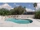 Backyard pool surrounded by lush greenery and a concrete patio with lounge chairs at 2712 Sidonia Ave, Las Vegas, NV 89102