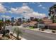 Street view of single-Gathering homes with tile roofs and well-maintained landscaping at 2712 Sidonia Ave, Las Vegas, NV 89102