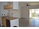 Open floor plan with view of the living room and sliding doors to the balcony from the kitchen at 2900 Sunridge Heights Pkwy # 1733, Henderson, NV 89052