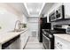 Galley kitchen featuring stainless steel appliances, granite counters, and ample cabinet space at 3120 S Eastern Ave # 6, Las Vegas, NV 89169
