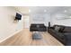 Modern living room showcasing hardwood floors, comfortable sofas, and a wall-mounted TV at 3120 S Eastern Ave # 6, Las Vegas, NV 89169