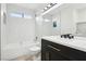 Elegant bathroom featuring black vanity, marble walls, and modern fixtures at 3132 Centavo Dr, Las Vegas, NV 89117