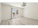 Bright bedroom features stylish light fixture, laminate flooring, and sliding glass doors to the backyard at 3132 Centavo Dr, Las Vegas, NV 89117