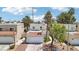 View of a two-story townhouse with a white garage door, driveway, and desert landscaping at 3132 Centavo Dr, Las Vegas, NV 89117