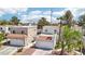View of a two-story townhouse with a white garage door, driveway, and desert landscaping at 3132 Centavo Dr, Las Vegas, NV 89117