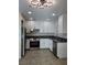 Modern kitchen featuring white cabinetry, stainless steel appliances, and dark countertops at 3132 Centavo Dr, Las Vegas, NV 89117