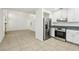 Bright kitchen with stainless steel appliances, white cabinets, and an adjoining living area at 3132 Centavo Dr, Las Vegas, NV 89117