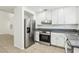 Bright kitchen featuring stainless steel appliances, white cabinets, and tile floors at 3132 Centavo Dr, Las Vegas, NV 89117