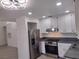 Bright kitchen with stainless steel appliances, granite countertops, and white cabinets at 3132 Centavo Dr, Las Vegas, NV 89117