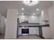 Modern kitchen featuring stainless steel appliances, white cabinetry, and a stylish ceiling light at 3132 Centavo Dr, Las Vegas, NV 89117
