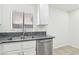 Kitchen features a stainless steel dishwasher, granite countertops and a double sink with window at 3132 Centavo Dr, Las Vegas, NV 89117