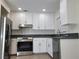 Bright kitchen with white cabinets, stainless steel appliances, and granite countertops at 3132 Centavo Dr, Las Vegas, NV 89117