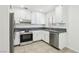Modern kitchen with stainless steel appliances, sleek countertops, and white cabinets at 3132 Centavo Dr, Las Vegas, NV 89117