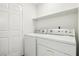 Functional laundry room equipped with washer and dryer units and a storage shelf at 3132 Centavo Dr, Las Vegas, NV 89117