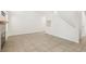 Bright living room with large windows, an open staircase, and tile floors at 3132 Centavo Dr, Las Vegas, NV 89117