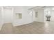Open-concept living space with tile floors, neutral walls, and an open staircase at 3132 Centavo Dr, Las Vegas, NV 89117
