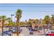 Commercial parking lot lined with palm trees and several parked cars under a cloudless sky at 3132 Centavo Dr, Las Vegas, NV 89117