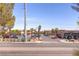 Commercial parking lot with many palm trees against a desert background on a sunny day at 3132 Centavo Dr, Las Vegas, NV 89117