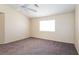 A cozy bedroom, featuring neutral walls, carpeted flooring, and a bright window at 3214 W Gilmore Ave, North Las Vegas, NV 89032