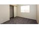 Bedroom with carpet, neutral walls, a closet, and a bright window at 3214 W Gilmore Ave, North Las Vegas, NV 89032