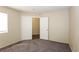 Bedroom with carpet, neutral walls, and a closet with double doors at 3214 W Gilmore Ave, North Las Vegas, NV 89032