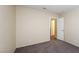 Bedroom featuring neutral walls, carpet, and a view to the hallway at 3214 W Gilmore Ave, North Las Vegas, NV 89032